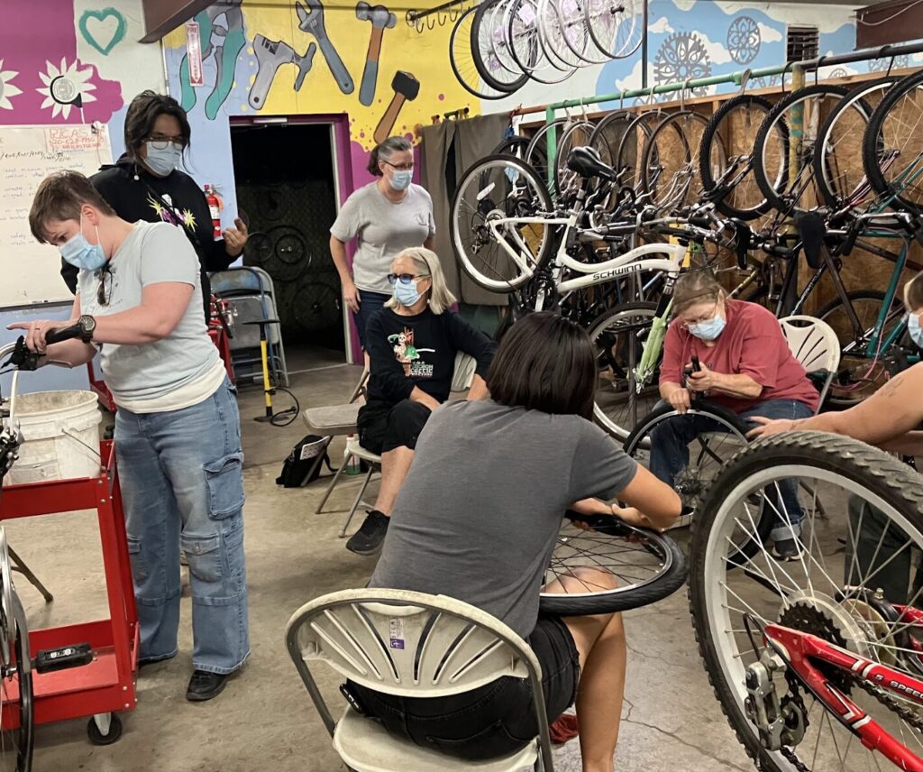 people working on bikes in the classroom